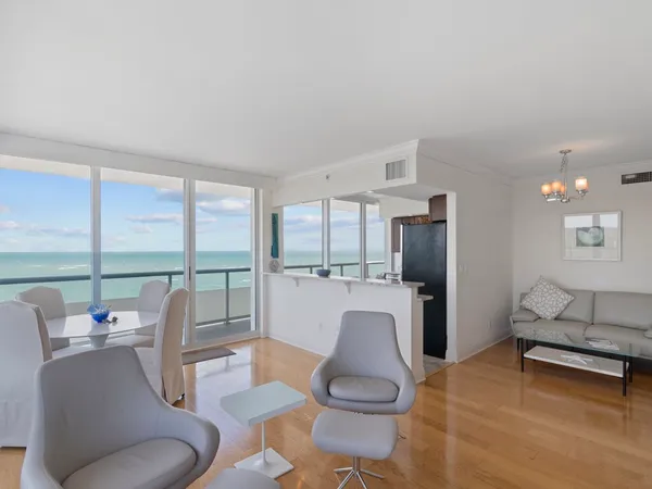 a living room with furniture and a floor to ceiling window