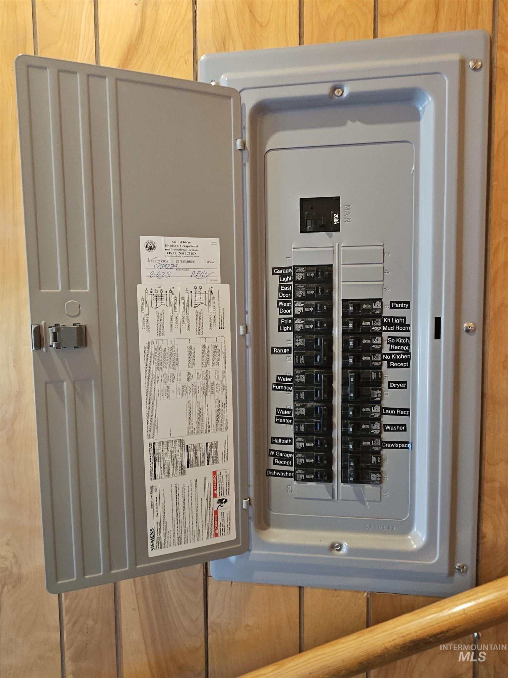 29865 Mission Creek Road Culdesac, ID 83524 - Photo 33 of 43 Updated electrical service panel with clearly labeled circuit breakers against wood-paneled walls