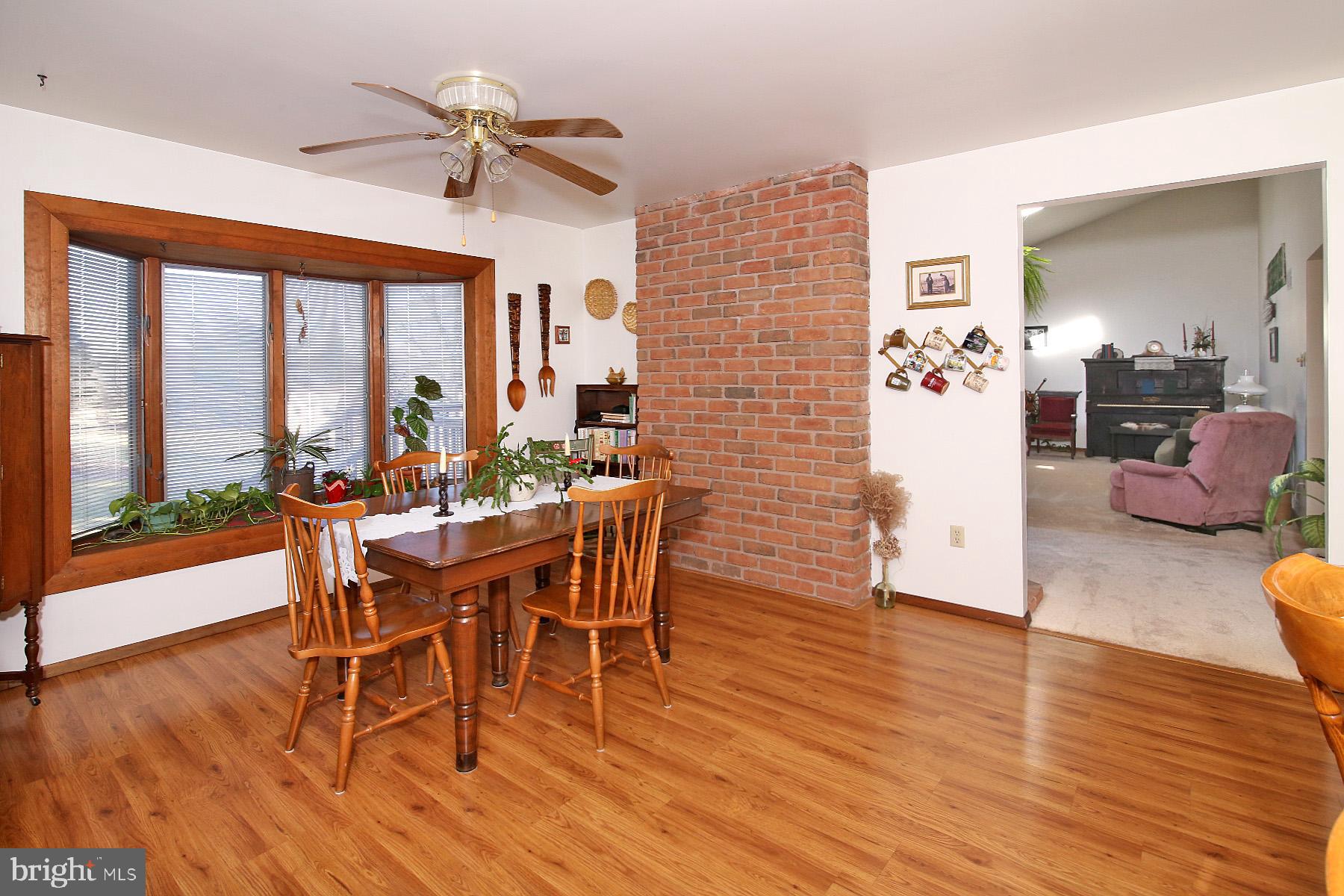 575 Bachmanville Road Hershey, PA 17033 - Photo 17 of 57 a view of a dining room with furniture window and wooden floor