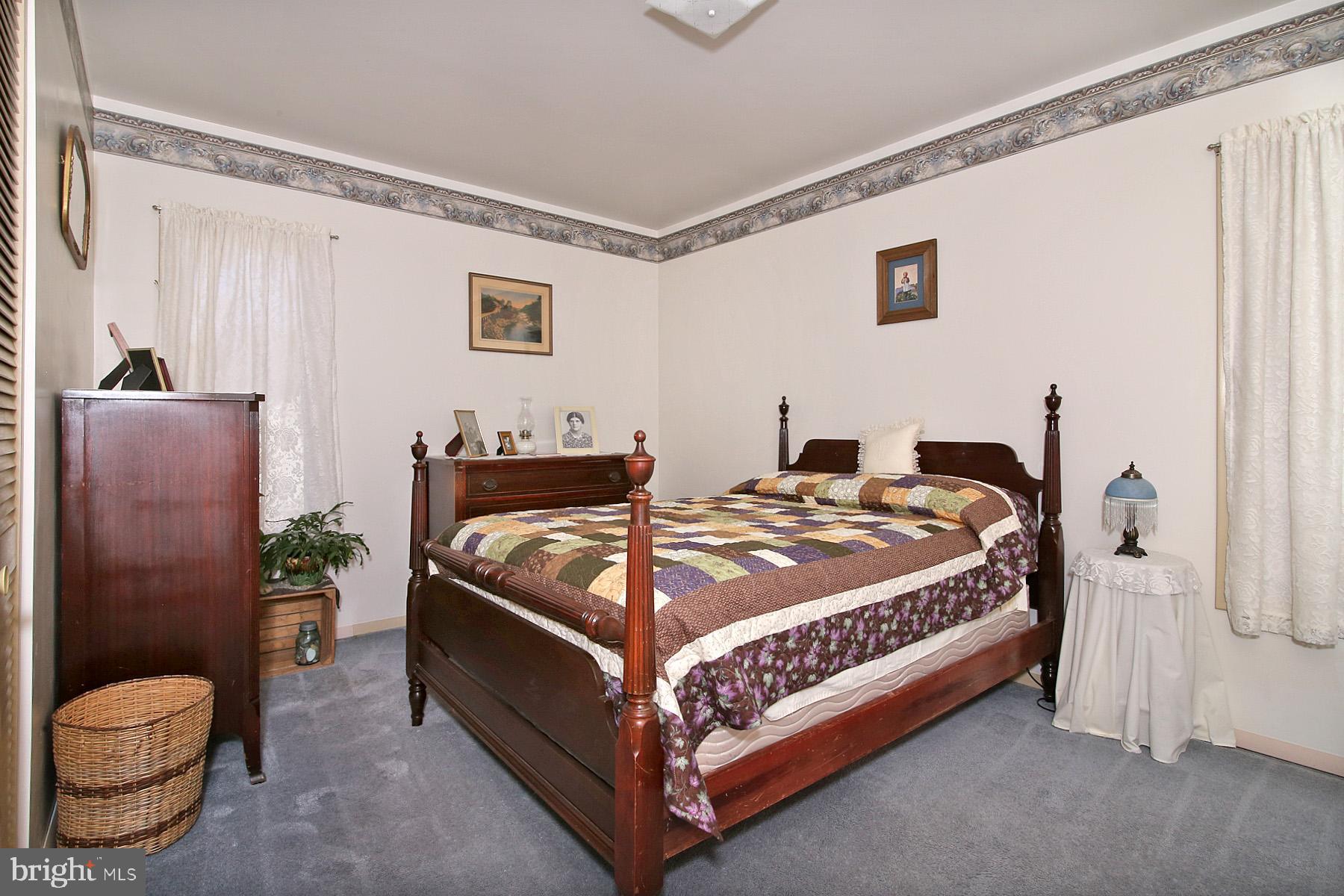 575 Bachmanville Road Hershey, PA 17033 - Photo 30 of 57 a bedroom with a bed and a potted plant