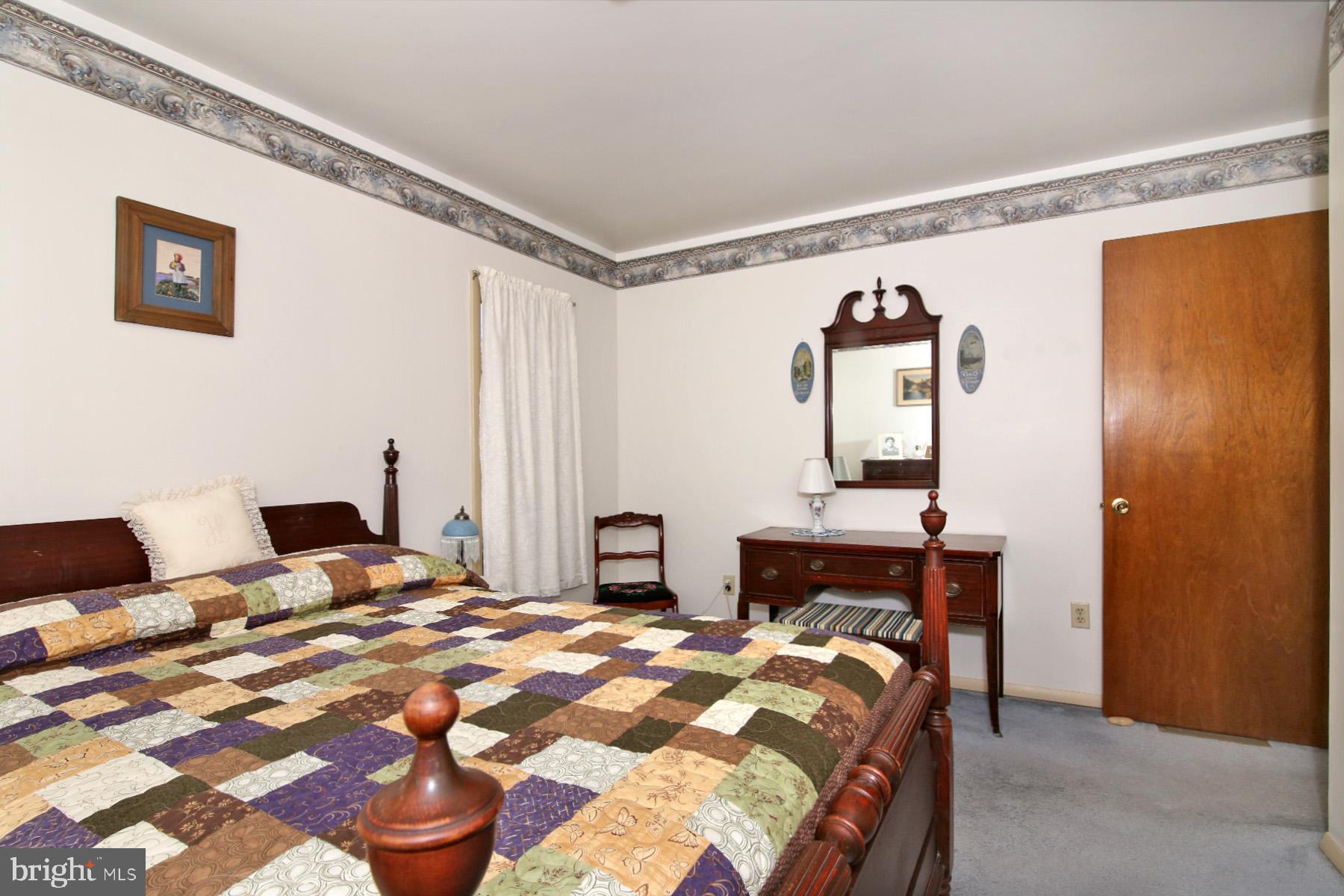 575 Bachmanville Road Hershey, PA 17033 - Photo 32 of 57 a bedroom with a bed and a chandelier