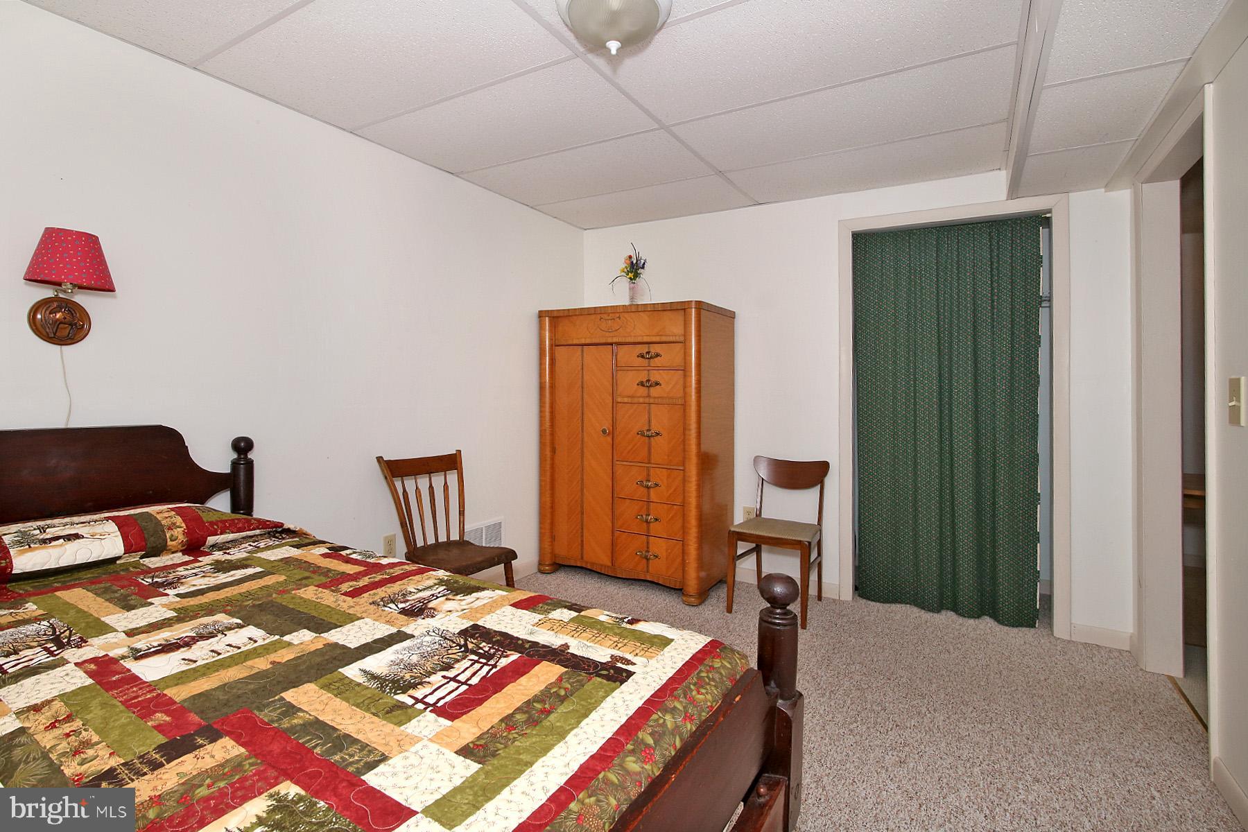 575 Bachmanville Road Hershey, PA 17033 - Photo 42 of 57 a bedroom with a bed and a chandelier