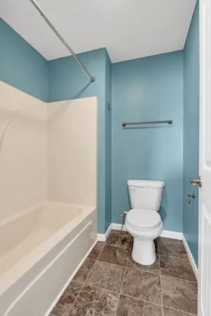 a bathroom with a toilet and a bathtub