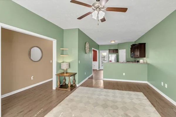 a view of a livingroom with a flat screen tv and couches
