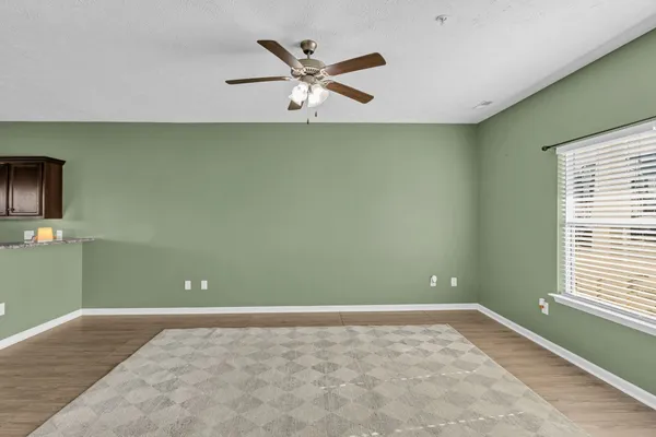 a view of a livingroom with a ceiling fan and a window