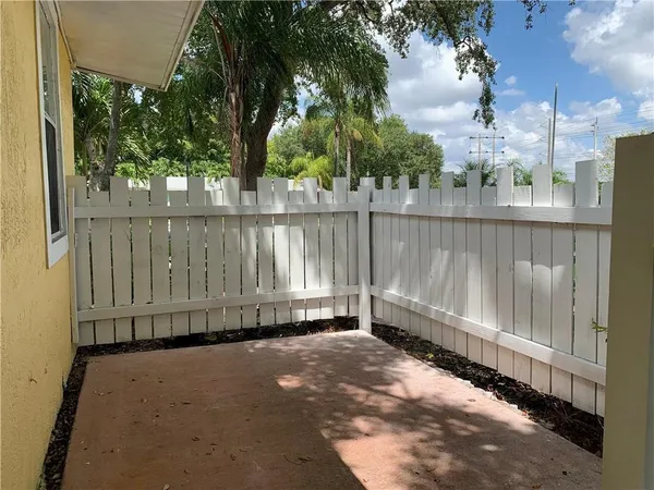 a view of a street with a large trees