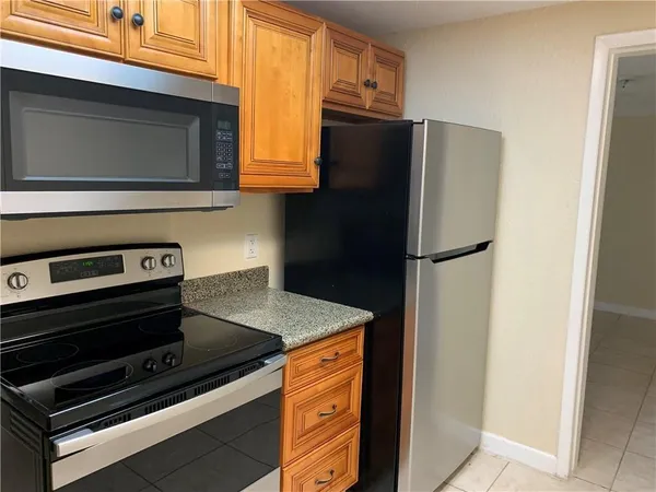 a kitchen with appliances and a microwave