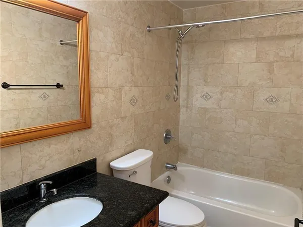a bathroom with a sink toilet a mirror and shower
