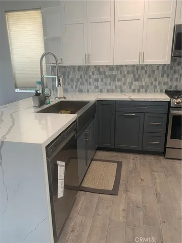 a kitchen with granite countertop a sink and a stove