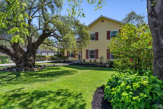 a brick house with trees in front of it