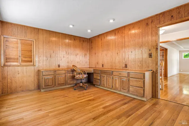a view of an empty room with a fireplace and a window