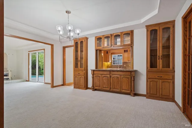 a view of a big room with windows and entryway of the house