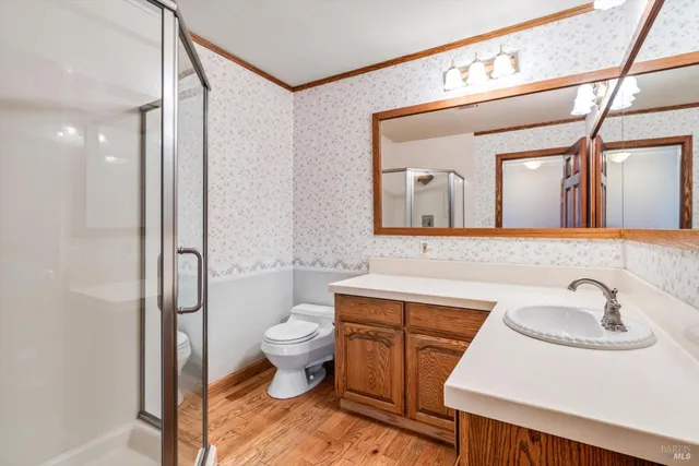 a view of a kitchen with furniture and wooden floor