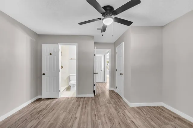 a view of an empty room and wooden floor