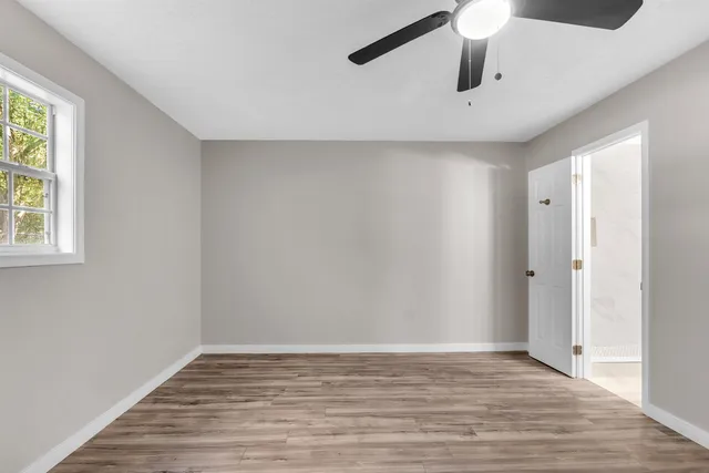 wooden floor in an empty room with a window