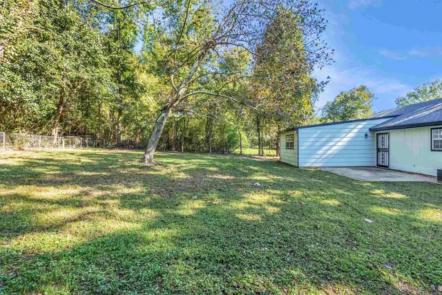 a backyard of a house with lots of green space