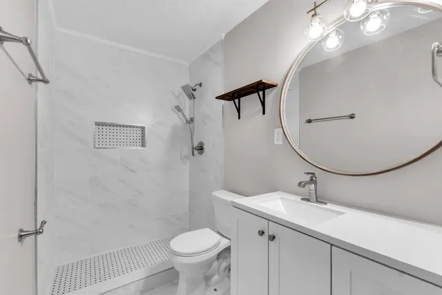 a bathroom with a sink toilet and shower