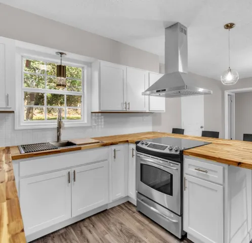 a kitchen that has a sink and a stove
