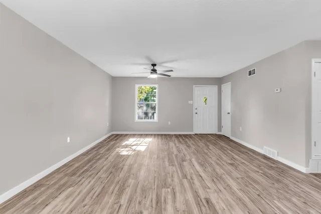wooden floor in an empty room with a window