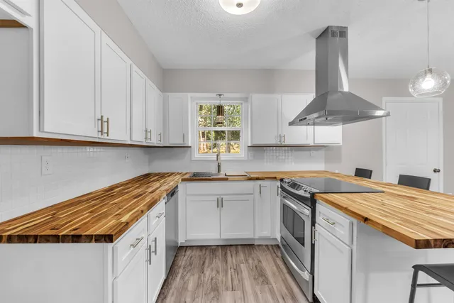 a kitchen with a sink a stove and cabinets