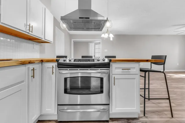 a kitchen with stainless steel appliances granite countertop a stove and a refrigerator
