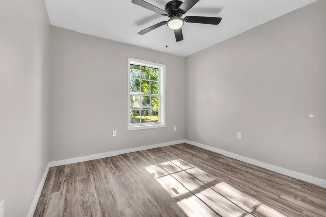 wooden floor in an empty room with a window