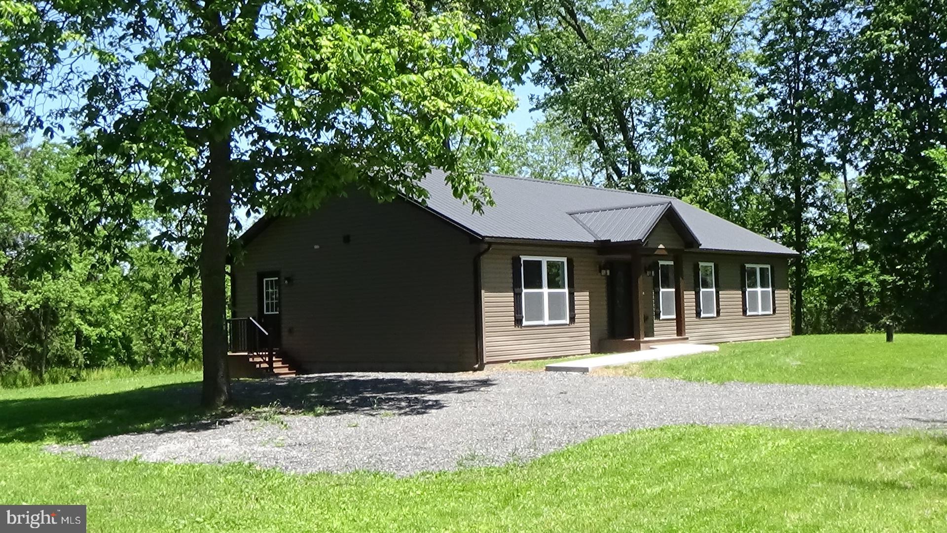 130 Soule Road New Bloomfield, PA 17068 - Photo 1 of 18 a front view of a house with a yard and garage