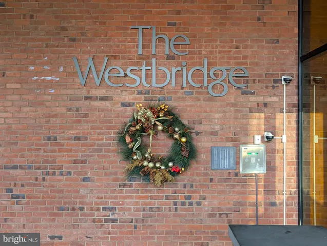 a sign that is on the brick wall