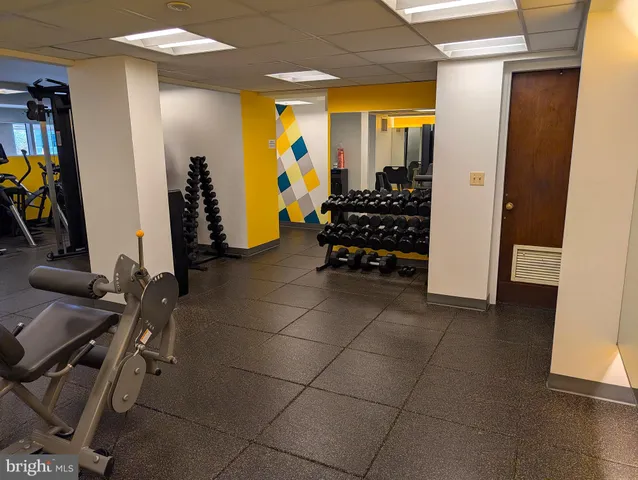 a view of a gym with swimming pool and sitting space