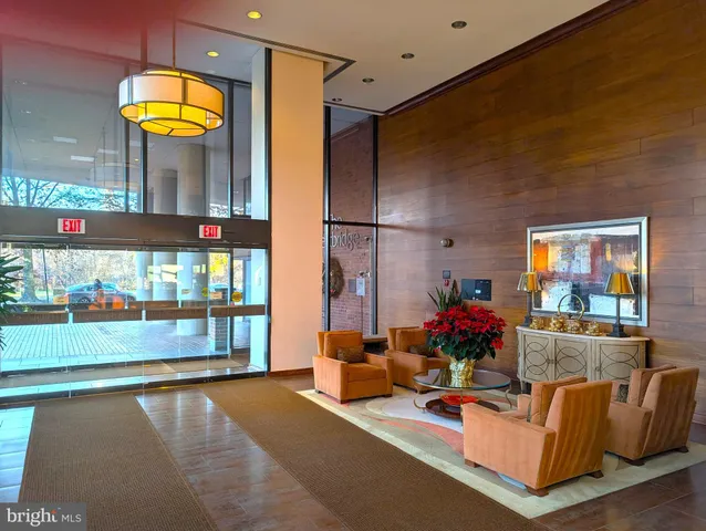 a living room with dining table and a large window