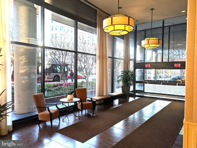 a vase of flowers sitting on a table with a mirror
