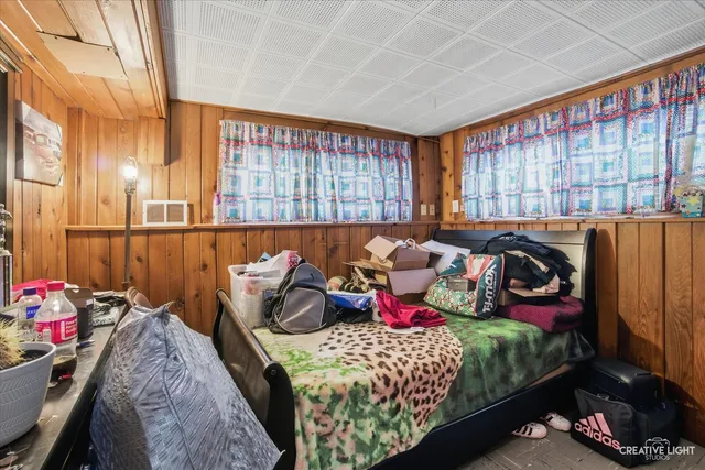 a bedroom with bed and a large window