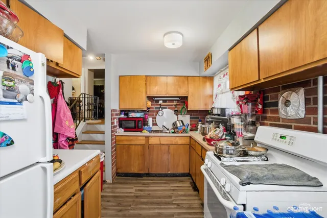 a open kitchen with stainless steel appliances granite countertop a stove and cabinets