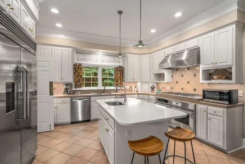 a kitchen with a sink stove top oven and refrigerator