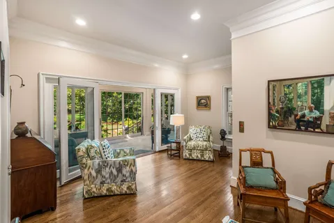 a living room with furniture and a book shelf