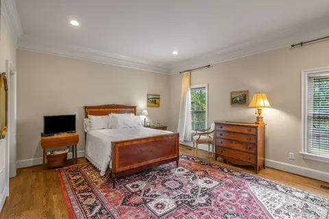 a bed room with a bed and a large window