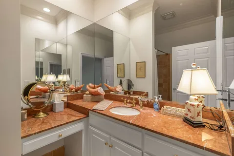 a bathroom with a tub sink and mirror