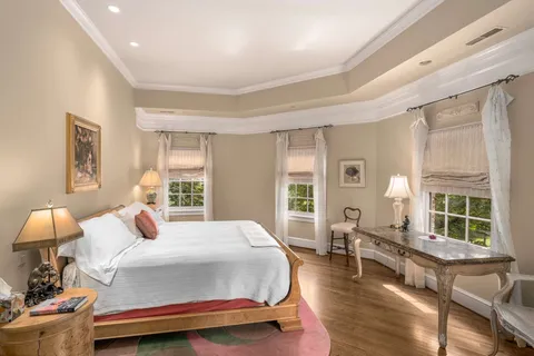 a bedroom with a bed window and a dresser