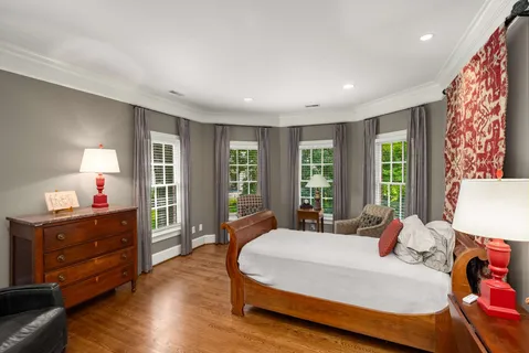 a view of a livingroom with bookshelf and a window