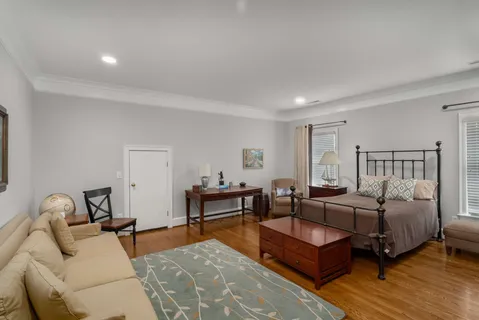 a bedroom with bed and a couch