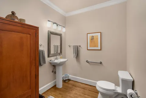 a bathroom with a toilet a sink and mirror