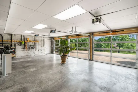 a view of a brick house with a yard and plants