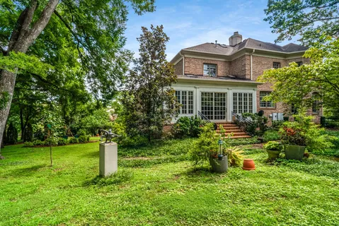 an aerial view of a house with a yard and lake view