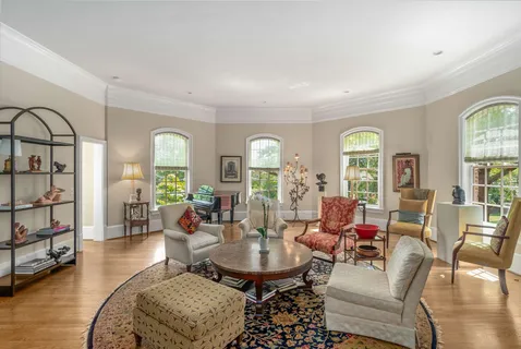 a living room with fireplace furniture and a window