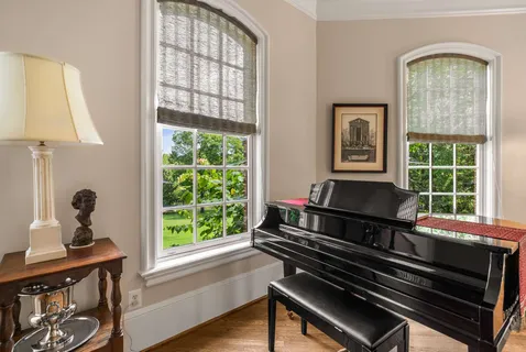 a very nice looking dining room with furniture window and wooden floor