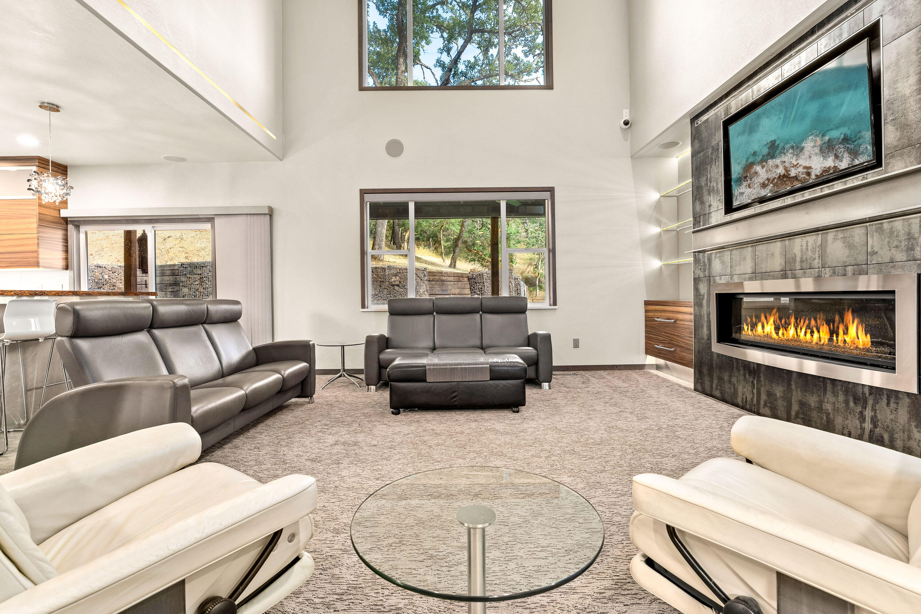 182 Wards Creek Road Rogue River, OR 97537 - Photo 17 of 80 a living room with furniture a fireplace a flat screen tv and a large window