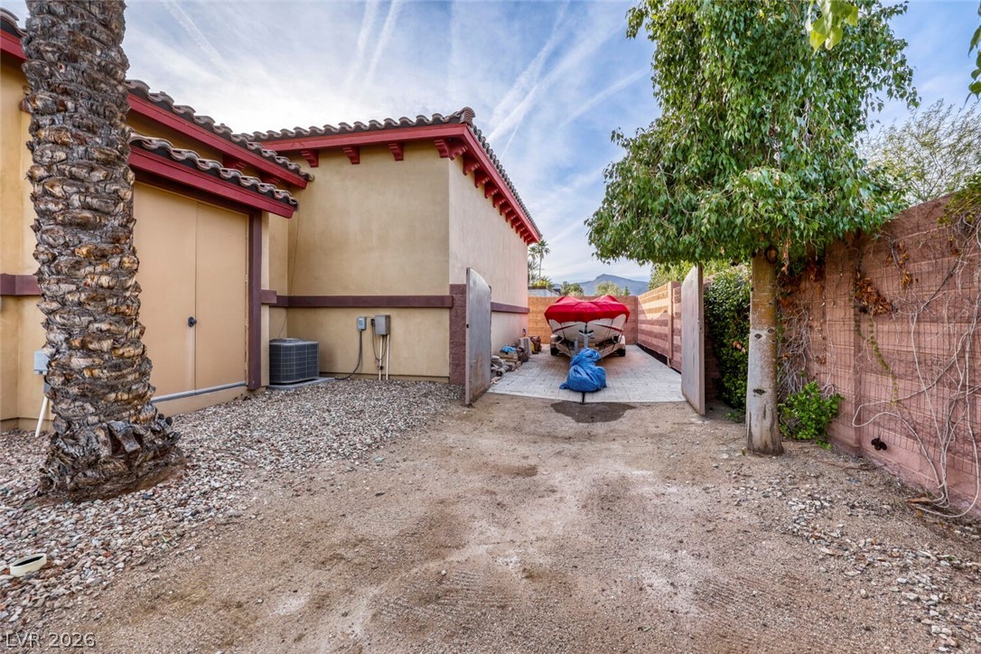 1065 Kratzer Circle Henderson, NV 89002 - Photo 58 of 62 View of side of property with a fenced backyard, stucco siding, and a tile roof