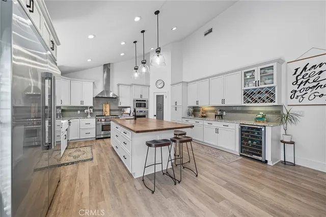 a kitchen with kitchen island granite countertop a sink stainless steel appliances and cabinets