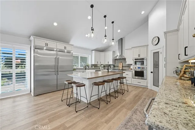 a kitchen with cabinets and wooden floor