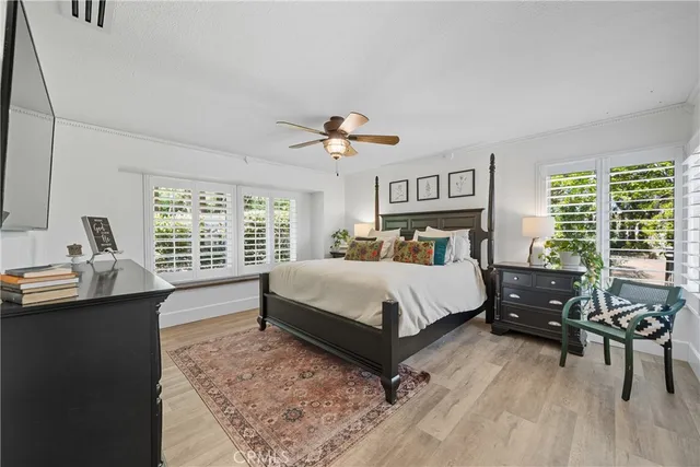a bedroom with a large bed and a large window